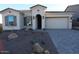 Inviting single-story home with desert landscaping, a two-car garage and a covered front entryway at 21369 W Hillcrest Blvd, Buckeye, AZ 85396