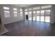 Bright living room featuring sleek floors, high windows, and multiple sliding glass doors to the backyard at 21369 W Hillcrest Blvd, Buckeye, AZ 85396
