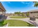 Landscaped backyard with a fire pit and patio at 22630 E Mewes Rd, Queen Creek, AZ 85142