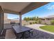 Outdoor dining area and lush backyard at 22630 E Mewes Rd, Queen Creek, AZ 85142