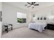 Bright bedroom with a queen-size bed, carpeted floors, and window with blinds at 22630 E Mewes Rd, Queen Creek, AZ 85142
