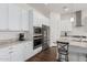 Modern kitchen with white cabinets, granite countertops, and stainless steel appliances at 22630 E Mewes Rd, Queen Creek, AZ 85142