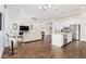 Combined kitchen and living area with hardwood floors and island at 22630 E Mewes Rd, Queen Creek, AZ 85142