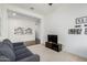 Open living room with gray sofa and view to dining area at 22630 E Mewes Rd, Queen Creek, AZ 85142
