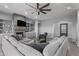 Bright living room with a stone fireplace, built-in shelving, and an oversized sectional couch at 12204 W Blackhawk Rd, Casa Grande, AZ 85194