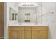 Double vanity bathroom with light wood cabinets and a large mirror at 7575 E Indian Bend Rd # 2081, Scottsdale, AZ 85250