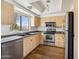 Kitchen with light wood cabinets and stainless steel appliances at 7575 E Indian Bend Rd # 2081, Scottsdale, AZ 85250