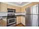 Kitchen with stainless steel appliances and light wood cabinets at 7575 E Indian Bend Rd # 2081, Scottsdale, AZ 85250