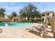 Community pool with lounge chairs and patio umbrellas at 7575 E Indian Bend Rd # 2081, Scottsdale, AZ 85250