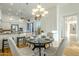 Bright dining area with hardwood floors and a modern chandelier at 7737 E Shooting Star Way, Scottsdale, AZ 85266