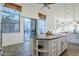 Kitchen island with granite countertop and built-in shelving at 7737 E Shooting Star Way, Scottsdale, AZ 85266