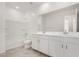 Bathroom featuring double sink vanity, tile floors, and shower over tub at 18002 W Vogel Ave, Goodyear, AZ 85338