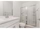 Clean bathroom featuring a glass-enclosed shower, white vanity, and modern fixtures at 18002 W Vogel Ave, Goodyear, AZ 85338