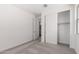 Bright bedroom featuring neutral walls and carpet, closet with sliding doors, and access to a private bathroom at 18002 W Vogel Ave, Goodyear, AZ 85338