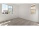 Bright bedroom with two windows and neutral carpet at 18002 W Vogel Ave, Goodyear, AZ 85338
