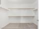 Walk-in closet featuring shelving with wooden rails and neutral carpet at 18002 W Vogel Ave, Goodyear, AZ 85338