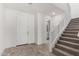 Bright entryway with tiled floors, a staircase, and white interior doors for a clean look at 18002 W Vogel Ave, Goodyear, AZ 85338