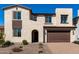 Charming two-story home featuring a brick driveway and a beautifully landscaped front yard at 18002 W Vogel Ave, Goodyear, AZ 85338