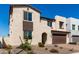 Charming two-story home featuring a brick driveway and a beautifully landscaped front yard at 18002 W Vogel Ave, Goodyear, AZ 85338