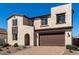 Charming two-story home featuring a brick driveway and a beautifully landscaped front yard at 18002 W Vogel Ave, Goodyear, AZ 85338