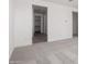Hallway leading to an open closet, with neutral-colored tile at 18002 W Vogel Ave, Goodyear, AZ 85338