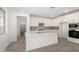 Open kitchen featuring a center island, stainless appliances, gray backsplash, and pantry access at 18002 W Vogel Ave, Goodyear, AZ 85338