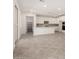 Open-concept kitchen featuring white cabinets, gray backsplash, and a large island with seating at 18002 W Vogel Ave, Goodyear, AZ 85338