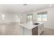 Open-concept view of kitchen and living space with center island and stainless dishwasher at 18002 W Vogel Ave, Goodyear, AZ 85338