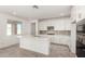 Bright kitchen with a center island, stainless appliances, and a view into the living room at 18002 W Vogel Ave, Goodyear, AZ 85338