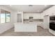 Well-lit kitchen with white cabinetry, a center island, stainless steel appliances, and tile flooring at 18002 W Vogel Ave, Goodyear, AZ 85338