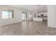 Bright living room with tile flooring, a large window, and sliding glass doors to the patio at 18002 W Vogel Ave, Goodyear, AZ 85338