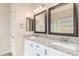 Bathroom features granite countertops, dual sinks, and framed mirrors at 707 W Coles Rd, Phoenix, AZ 85041