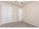 Bedroom with carpet, ceiling fan, and a closet with double doors at 707 W Coles Rd, Phoenix, AZ 85041