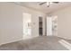 Bedroom featuring a neutral color scheme, carpet flooring, and open doorway to bathroom and walk-in closet at 707 W Coles Rd, Phoenix, AZ 85041