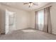 Inviting bedroom with carpet, light walls, ceiling fan, and a window with sheer curtains at 707 W Coles Rd, Phoenix, AZ 85041