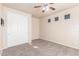 Bedroom with carpet, ceiling fan, and a closet with double doors at 707 W Coles Rd, Phoenix, AZ 85041