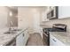 Modern kitchen with stainless steel appliances, granite countertops, and tile flooring at 707 W Coles Rd, Phoenix, AZ 85041