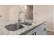 Kitchen island with a stainless steel sink, granite countertop, and white cabinetry at 707 W Coles Rd, Phoenix, AZ 85041