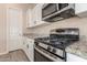 Well-appointed kitchen featuring stainless steel oven and microwave plus granite counters at 707 W Coles Rd, Phoenix, AZ 85041