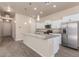 Modern kitchen with granite countertops, stainless steel appliances, and white cabinetry at 707 W Coles Rd, Phoenix, AZ 85041