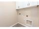 Bright laundry room with white cabinets and utility connections at 707 W Coles Rd, Phoenix, AZ 85041