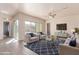 Bright living room featuring hardwood floors, sliding glass doors, and stylish seating arrangement with a cozy rug at 707 W Coles Rd, Phoenix, AZ 85041