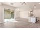 Spacious living area with an open layout, light colored walls, and sliding glass door to the backyard at 707 W Coles Rd, Phoenix, AZ 85041