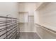 Walk-in closet with built-in shelves and a rack for shoe storage at 707 W Coles Rd, Phoenix, AZ 85041