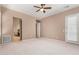 Large bedroom features carpet, ceiling fan, and access to a private patio at 26747 N 127Th Dr, Peoria, AZ 85383