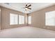Spacious bedroom with a ceiling fan and carpet flooring at 26747 N 127Th Dr, Peoria, AZ 85383