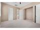 Spacious bedroom featuring neutral carpet, ceiling fan, and multiple closets for ample storage at 26747 N 127Th Dr, Peoria, AZ 85383
