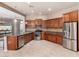 Well-equipped kitchen with stainless steel appliances, granite countertops, and tiled flooring at 26747 N 127Th Dr, Peoria, AZ 85383