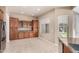 Spacious kitchen area featuring granite counters, tile flooring, and wood cabinets at 26747 N 127Th Dr, Peoria, AZ 85383