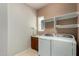 Laundry room with a sink, shelving, and modern washing machine and dryer at 26747 N 127Th Dr, Peoria, AZ 85383